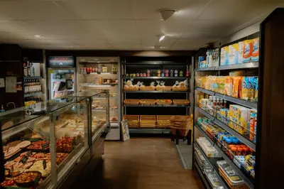 a store aisle of a grocery store filled with food at Landal North Lakes