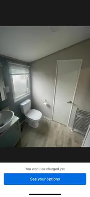 a bathroom with a white toilet and a sink at Loch View 30 in Stranraer