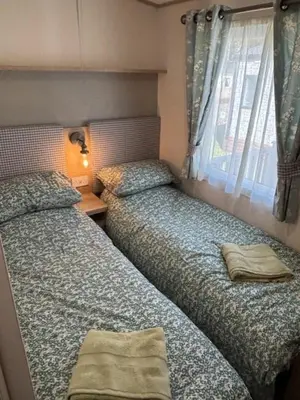 a bedroom with two beds and a window at Deblisa in Longtown