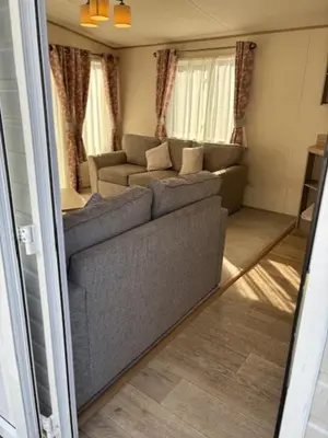 a living room with a couch and a couch and a table at Deblisa in Longtown