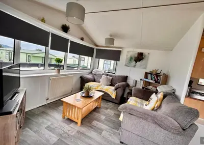 a living room with a couch and a table at Loch View 28 in Stranraer