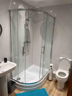 a bathroom with a shower with a toilet and a sink at Woodlane 3bedroom7 seater hottub and a pool table in Beeswing