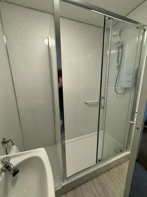 a glass shower in a bathroom with a sink at Ayr 2 bed apartment in Ayr