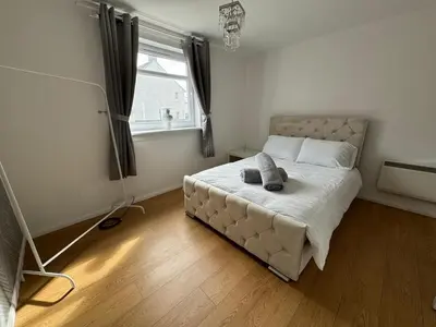 a bedroom with a bed and a window at Ayr 2 bed apartment in Ayr