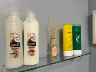 a shelf with four bottles of milk on it at Ayr 2 bed apartment in Ayr