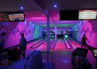 a bowling alley with people playing a game of bowling at Stanwix Park in Silloth