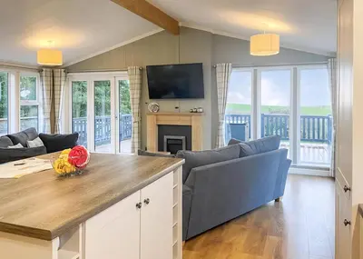 a living room with a couch and a table at Whitecairn Holiday Park in Glenluce