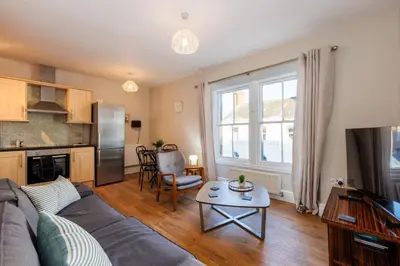 a living room with a couch and a table at North Loft a Modern Apartment in Cockermouth in Cockermouth