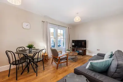 a living room with a couch and a table at North Loft a Modern Apartment in Cockermouth in Cockermouth