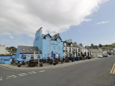 a blue building on the side of a street at Ellies House in Stranraer