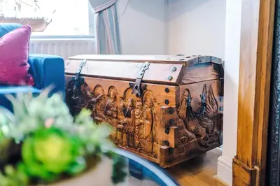 a trunk sitting on a table in a living room at Springholm Cottage Family Retreat - Sleeps 10 in Bootle