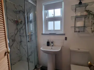 a bathroom with a sink and a shower at Lane Head Farm Country Guest House in Troutbeck