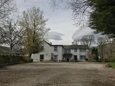 a large white stone house with a driveway at Lane Head Farm Country Guest House in Troutbeck