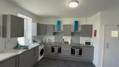a kitchen with a sink and a stove top oven at Esk View House in Carlisle