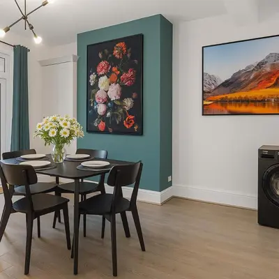 a dining room with a table and a painting of flowers at Harrington Haven - 4bed Home Workington in Workington