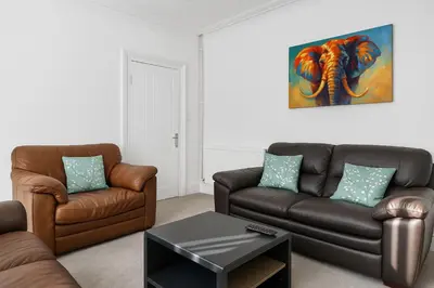 a living room with two couches and a table at Harrington Haven - 4bed Home Workington in Workington