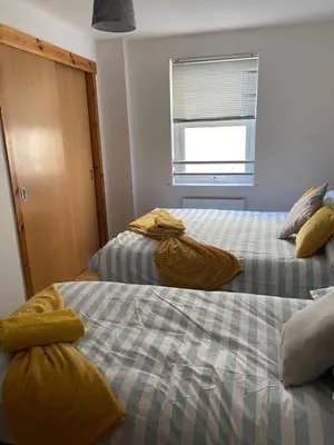 two beds sitting next to each other in a room at Number one faraline in Moffat
