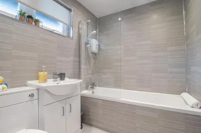 a bathroom with a sink and a tub and a toilet at Corsehill Cottage - 3 Bedroom, 2 bathroom House in Dreghorn