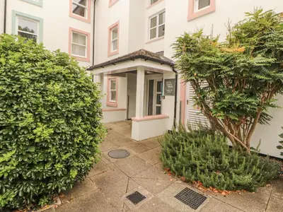 an entrance to a building with two large bushes at Flat 17 Greta Grove in Keswick