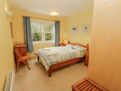 a bedroom with a bed and a window at Flat 17 Greta Grove in Keswick