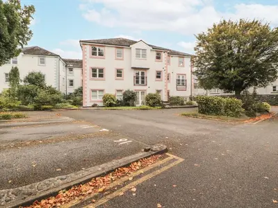 an empty street in front of a large house at Flat 17 Greta Grove in Keswick