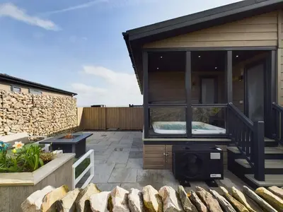 a house with a balcony with a bed in it at Landal Ullswater Heights in Great Blencow