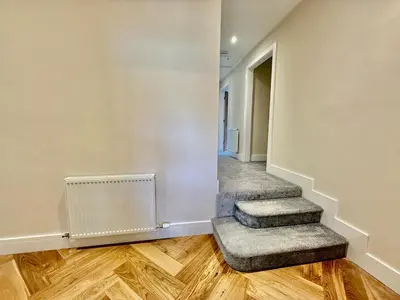 an empty hallway with stairs and a stair case at Jaytrees, Keswick - Luxury bungalow with hot tub in Keswick