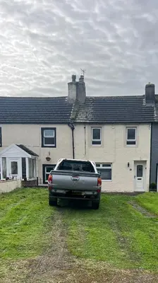 a car parked in front of a house at Cottage in Seaton in Siddick