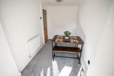 a room with a table with a plant on it at Cottage in Seaton in Siddick