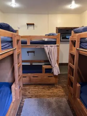 a room with three bunk beds in a room at The White Hart Inn & Bunkhouse in Moffat