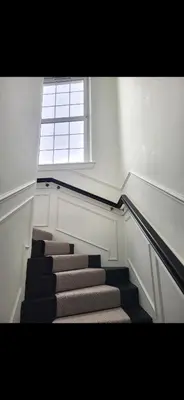 a stairway with a window and a stair case at Kirkgate 2 bed - Coorie Doon Stays in Irvine