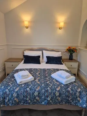 a bedroom with a bed with two towels on it at Kirkgate 2 bed - Coorie Doon Stays in Irvine