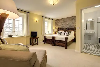 a bedroom with a bed and a sink in a room at Lowthwaite B&B in Watermillock