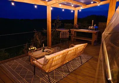 a wooden deck with a bathtub and a table at Coorie Retreats Luxury Geo Domes and Cabins with Private Hot Tubs Cinema Firepit Spa and More in Portpatrick