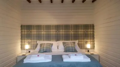 a bedroom with a bed with two towels on it at Mountain Lodge, Lake View, National Park in Borrowdale Valley