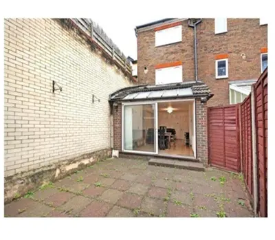 an empty patio in front of a brick building at 14 Maple Mews in Moffat
