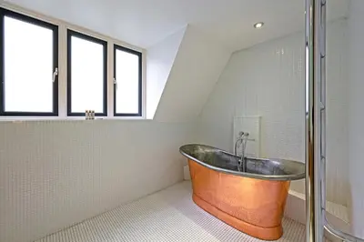 a bath tub in a bathroom with windows at Arcore London Premium Apartment Liverpool Street in Moffat