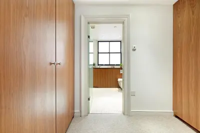 a bathroom with a door leading into a bathroom with a sink at Arcore London Premium Apartment Liverpool Street in Moffat