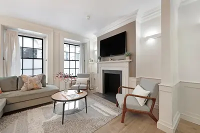 a living room with a couch and a fireplace at Arcore London Premium Apartment Liverpool Street in Moffat