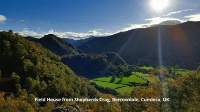 a view of a valley with the sun shining through the mountains at 2 Double Bed Cottage Hottub Lake District Keswick in Keswick