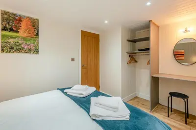 a bedroom with a bed with two towels on it at 2 Bed in Mouswald oc-b33444 in Mouswald
