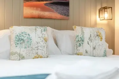 a white bed with two pillows on top of it at 2 Bed in Mouswald oc-b33444 in Mouswald