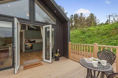 a patio with a table and chairs on a deck at 2 Bed in Mouswald oc-b33444 in Mouswald