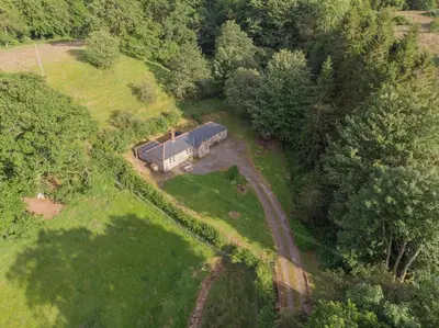 an aerial view of a house in a field at Morton Mains Cottage