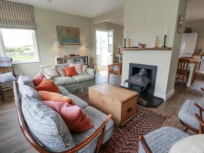 a living room with a couch and a fireplace at The Dairy in Newton Stewart