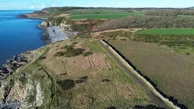 an aerial view of a cliff next to the ocean at The Dairy in Newton Stewart