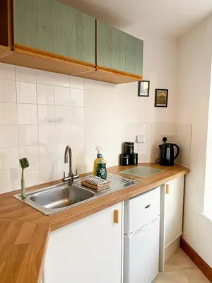a kitchen with a sink and a counter top at Hadrians Retreat, Cosy 1 Bed Flat - near M6 Jct45, A75, Gretna & Carlisle in Longtown