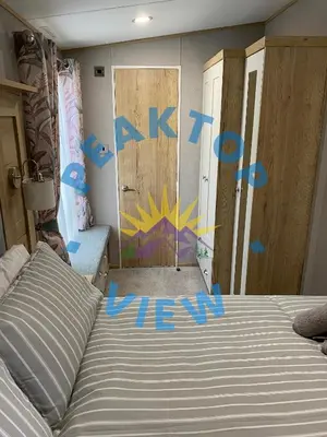 a bedroom with a bed and a door with the words exit at Peaktop View, Winscales, near Cockermouth Cumbria in Winscales