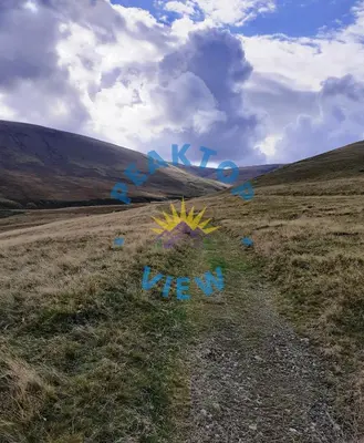 a grassy field with graffiti on the ground at Peaktop View, Winscales, near Cockermouth Cumbria in Winscales
