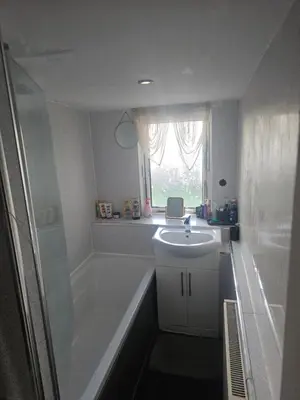 a bathroom with a tub and a sink and a bath tub at Sandylands in Braystones